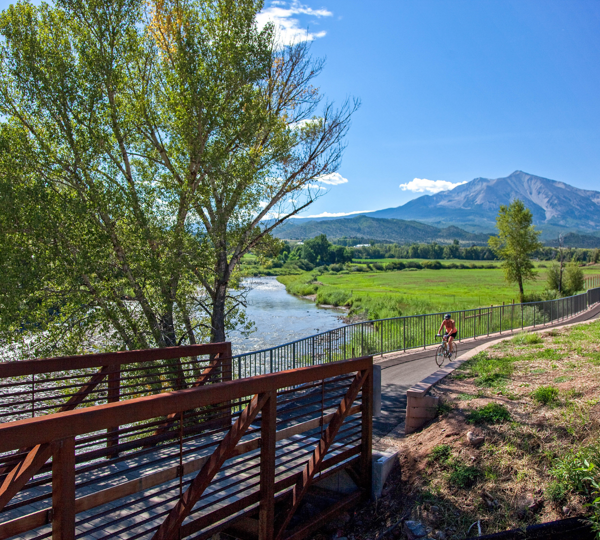 A bicyclist on the Crystal Trail with Mount Sopris in distance. Photo by John Fielder.